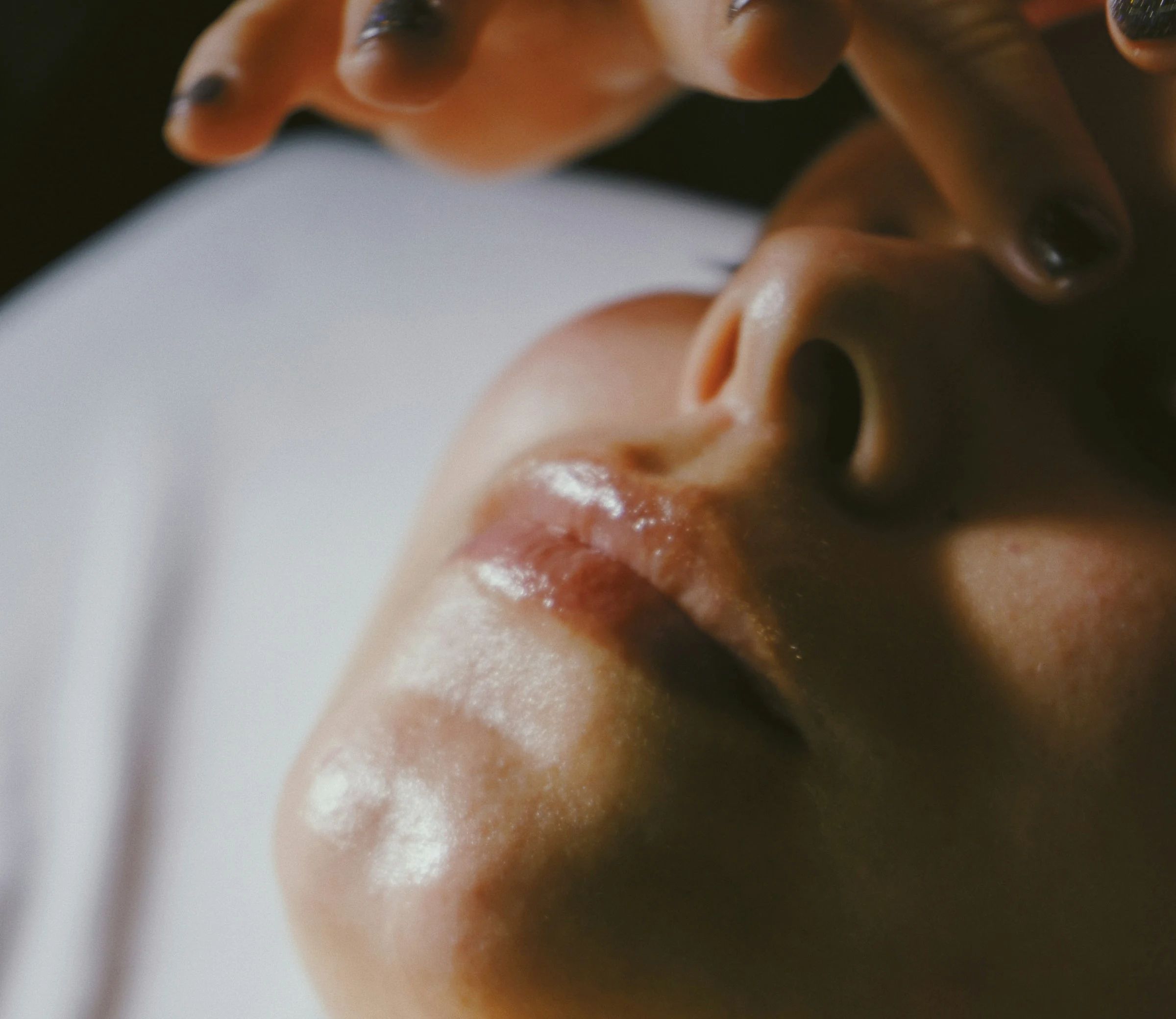A woman relaxing with her eyes closed during a facial massage