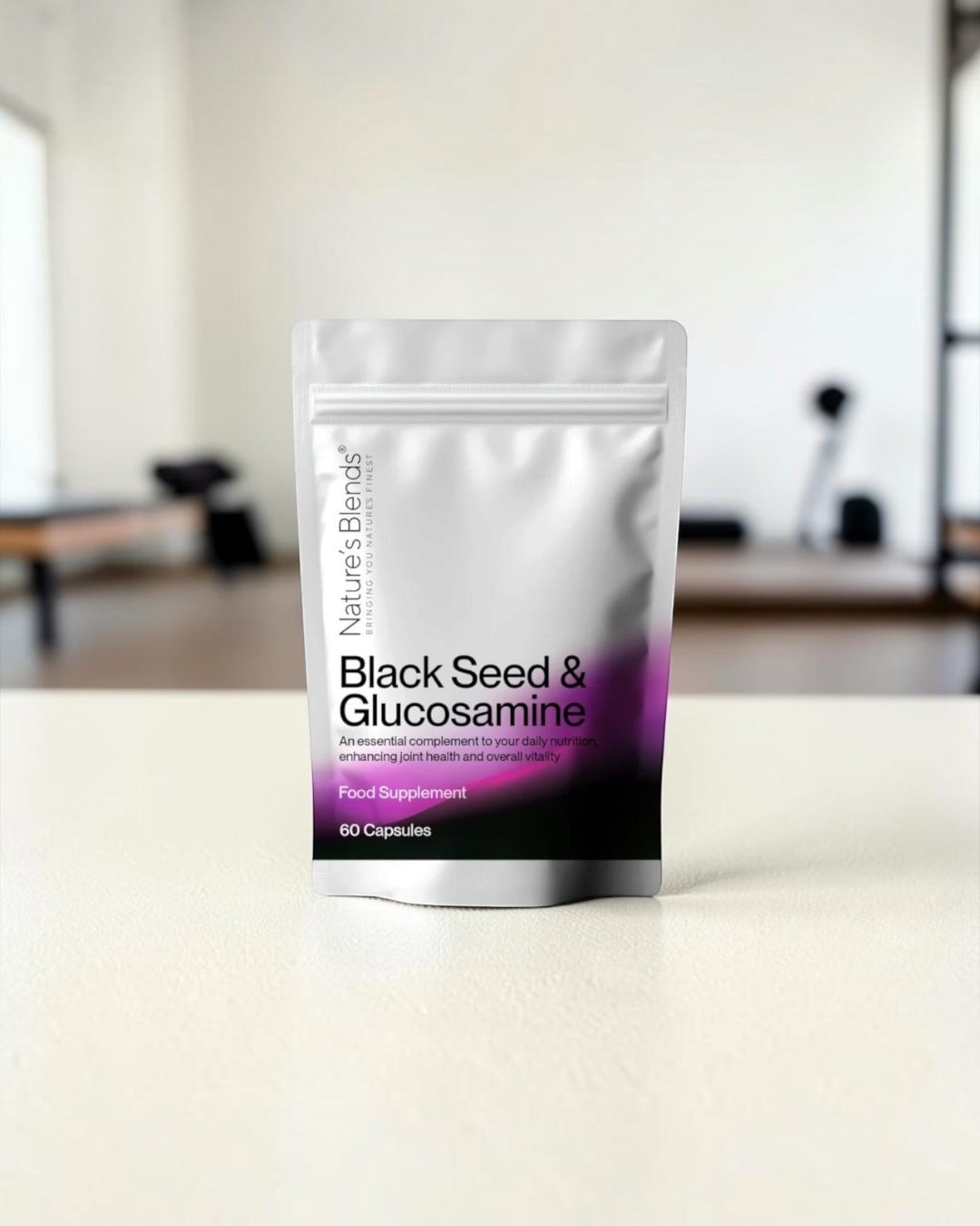 A pouch of Nature's Blends Black Seed & Glucosamine capsules on a pale table